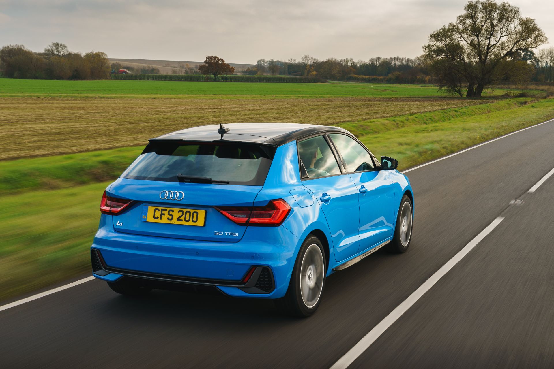 2026 audi a1 sportback s line driving rear three quarter country road blue