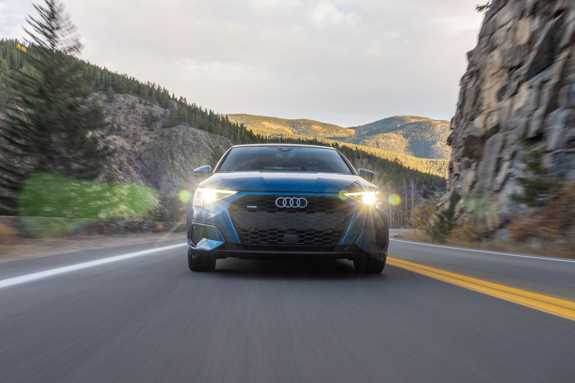 audi a3 driving front mountain road atoll blue