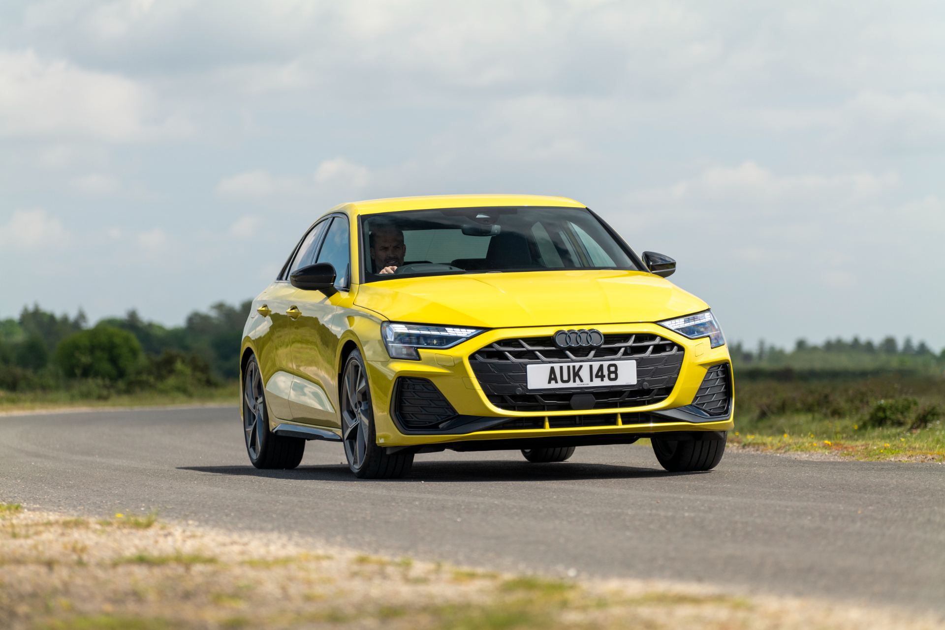 2025 audi a3 saloon driving front three quarter yellow