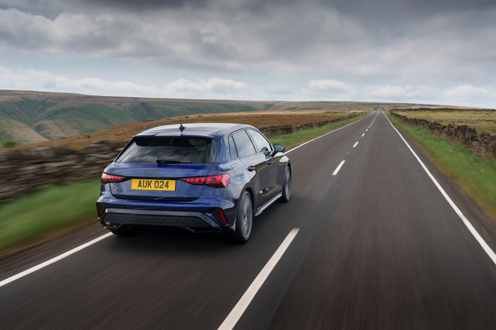 2025 audi a3 sportback driving rear moorland road blue