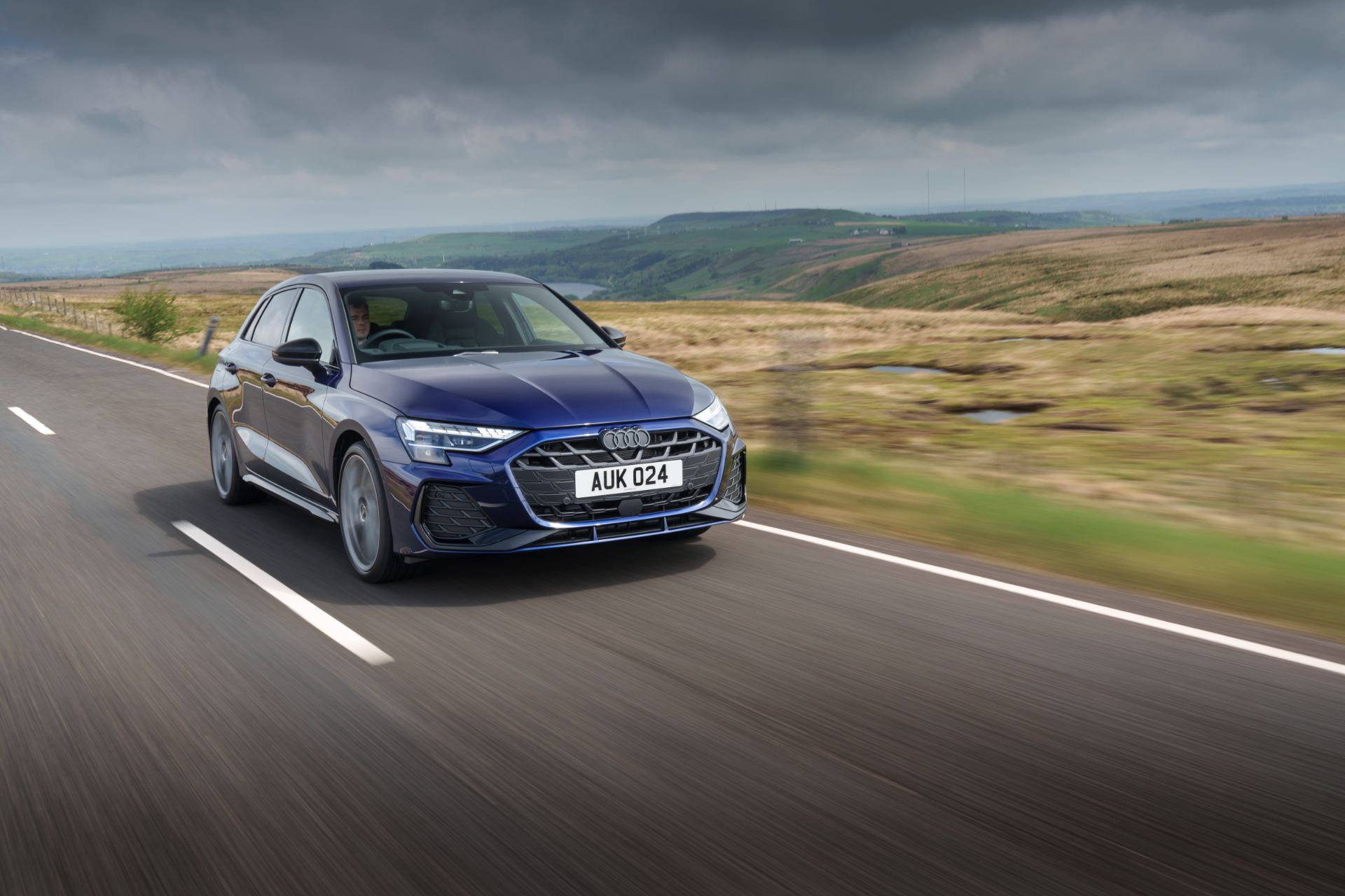 2025 audi a3 sportback driving front three quarter moorland blue