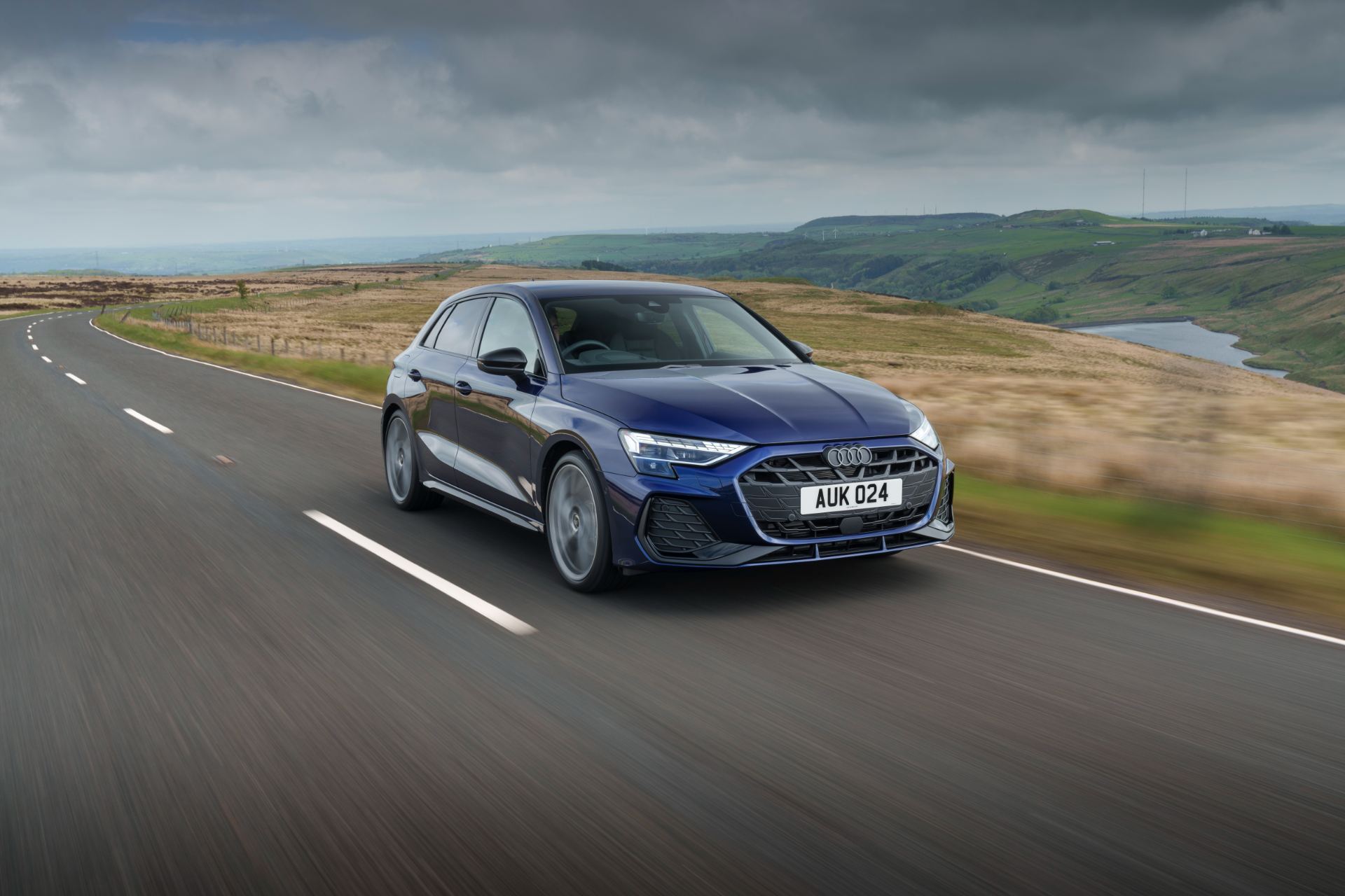 2025 audi a3 sportback driving front three quarter reservoir blue