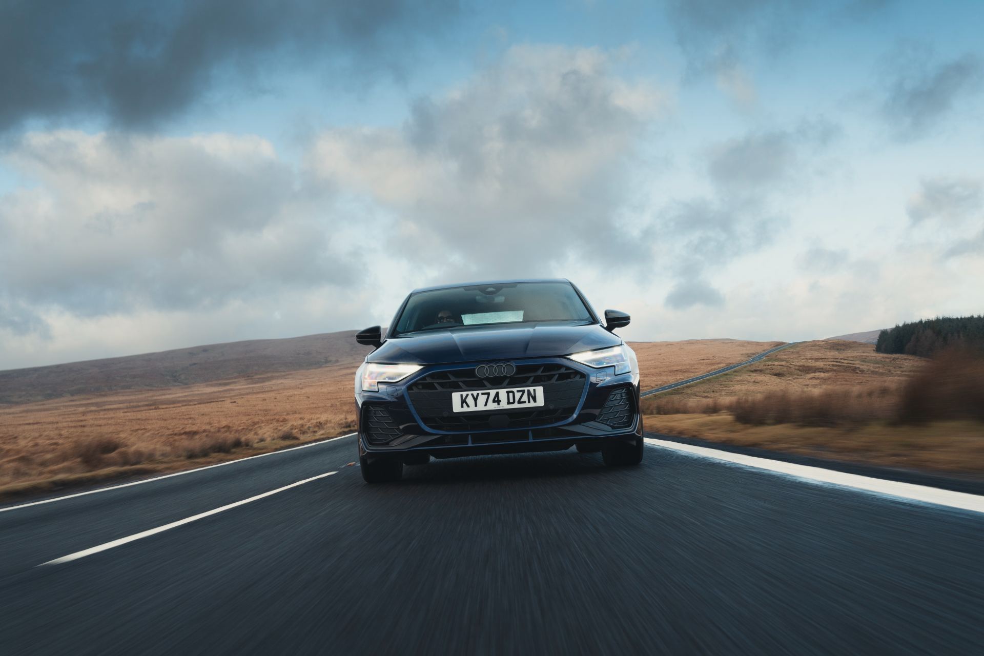 2025 audi a3 sportback tfsi e driving front moorland blue