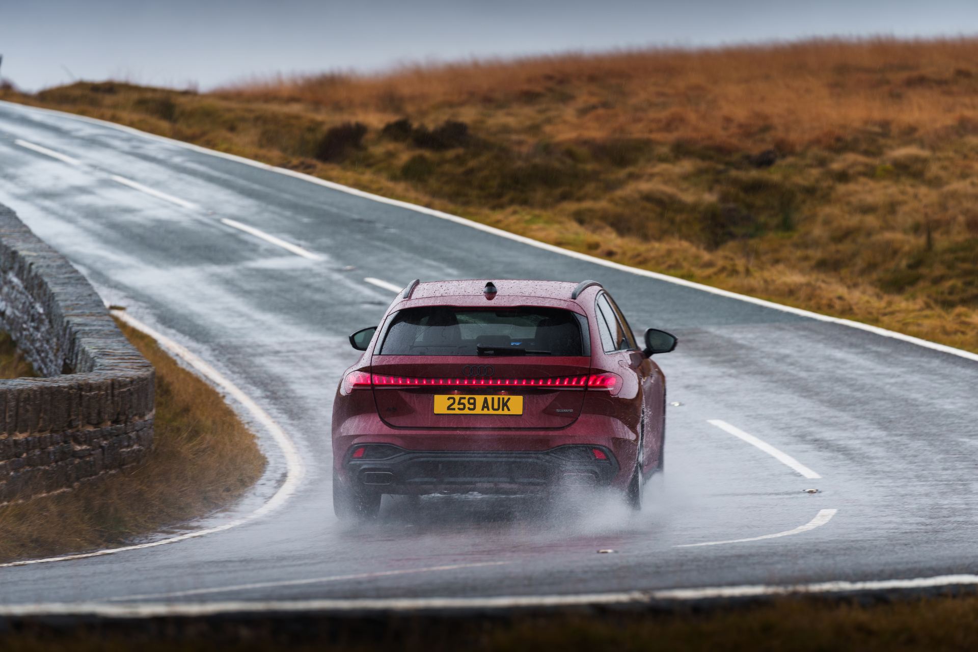 audi a5 avant driving rear wet road red