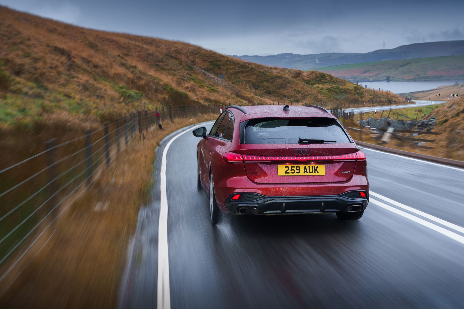 audi a5 avant driving rear winding road red