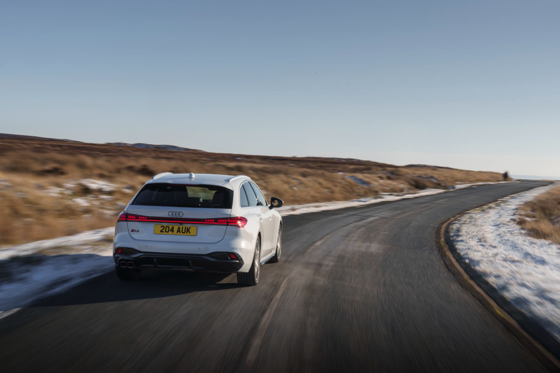 audi a5 avant driving rear winding road white