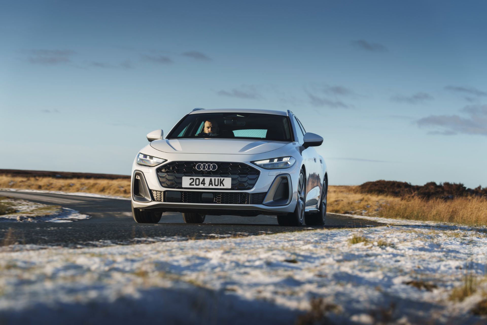 audi a5 avant driving front snowy road white
