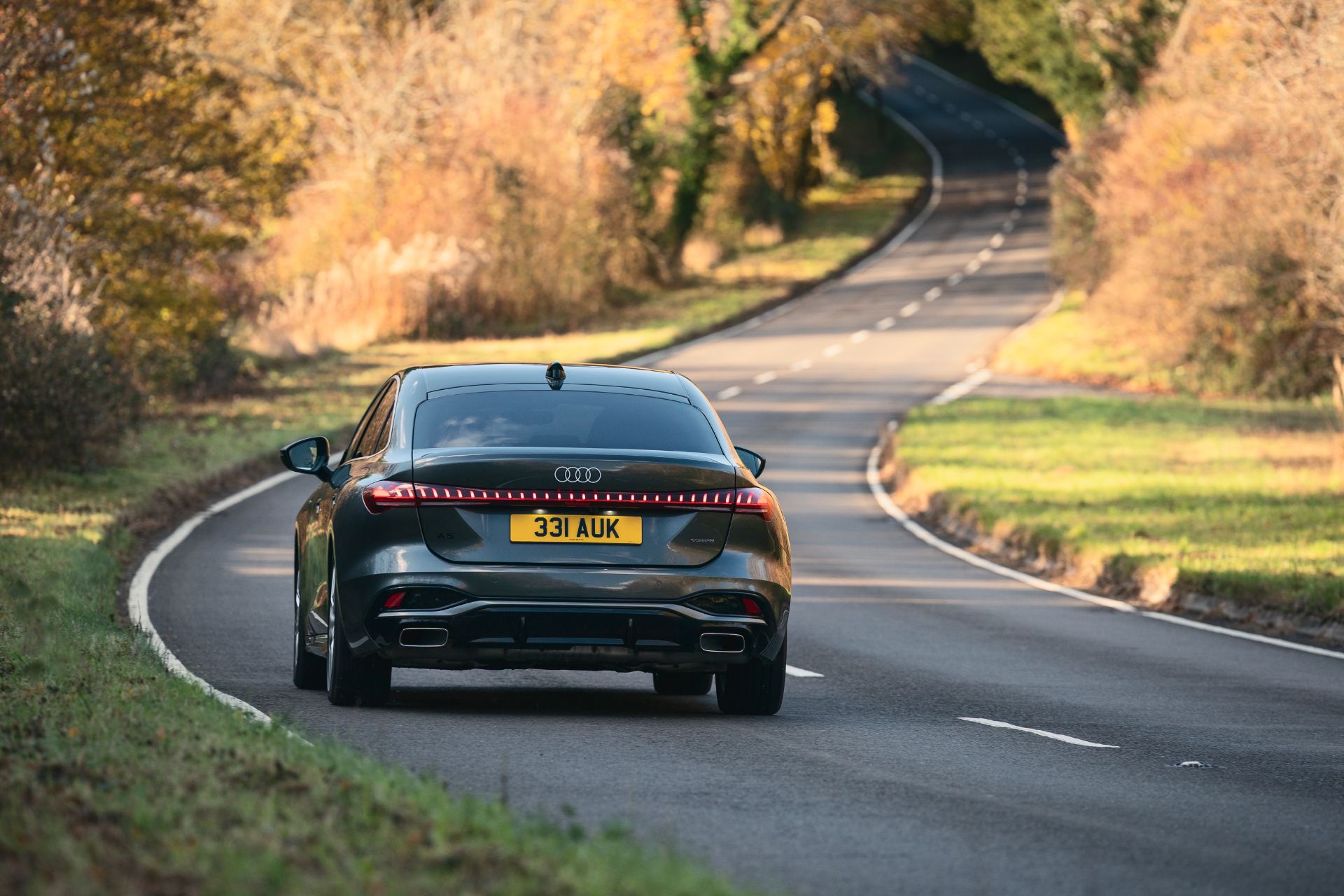 2026 audi a5 saloon e hybrid driving rear autumn lane grey