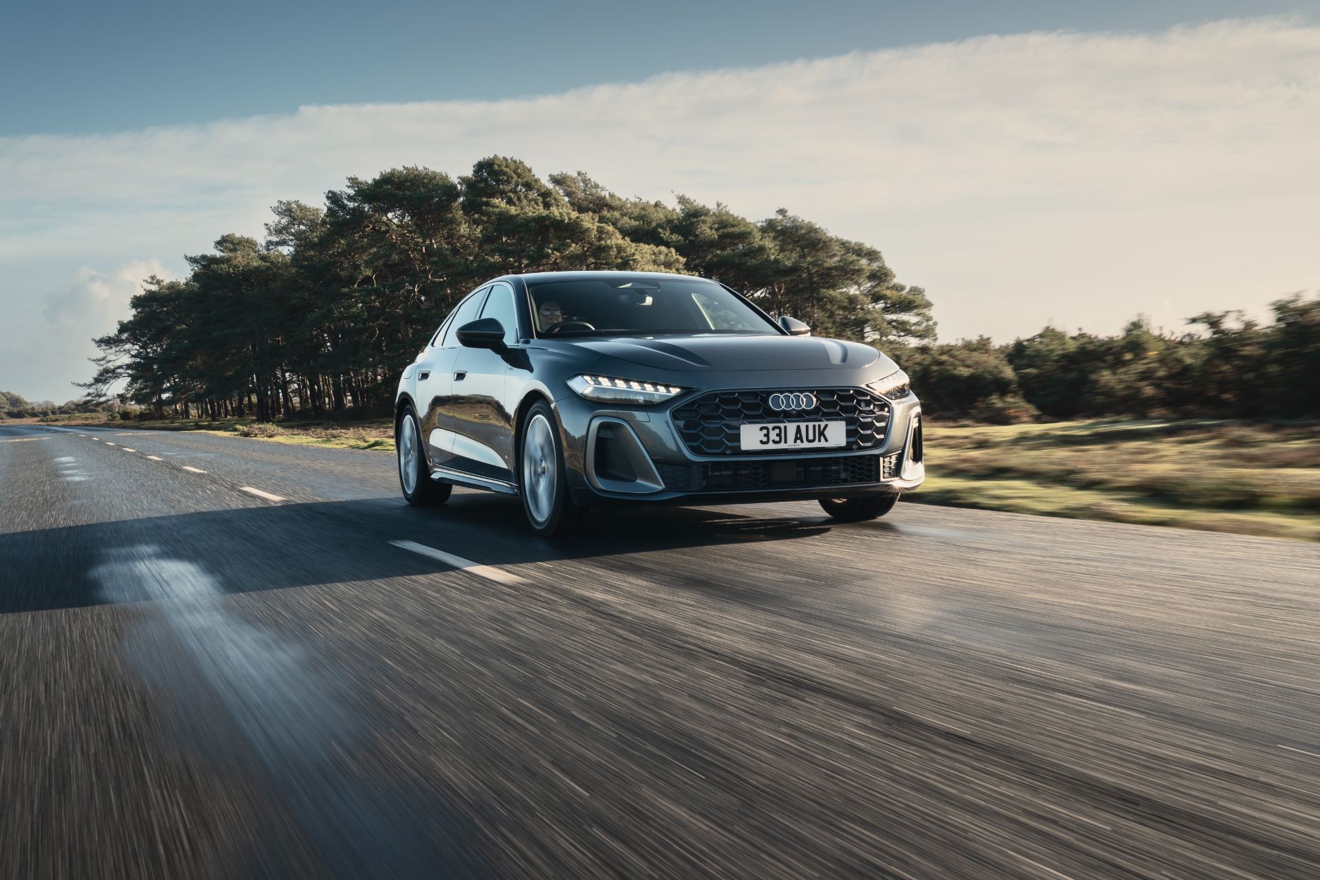 2026 audi a5 saloon e hybrid driving front three quarter heath grey