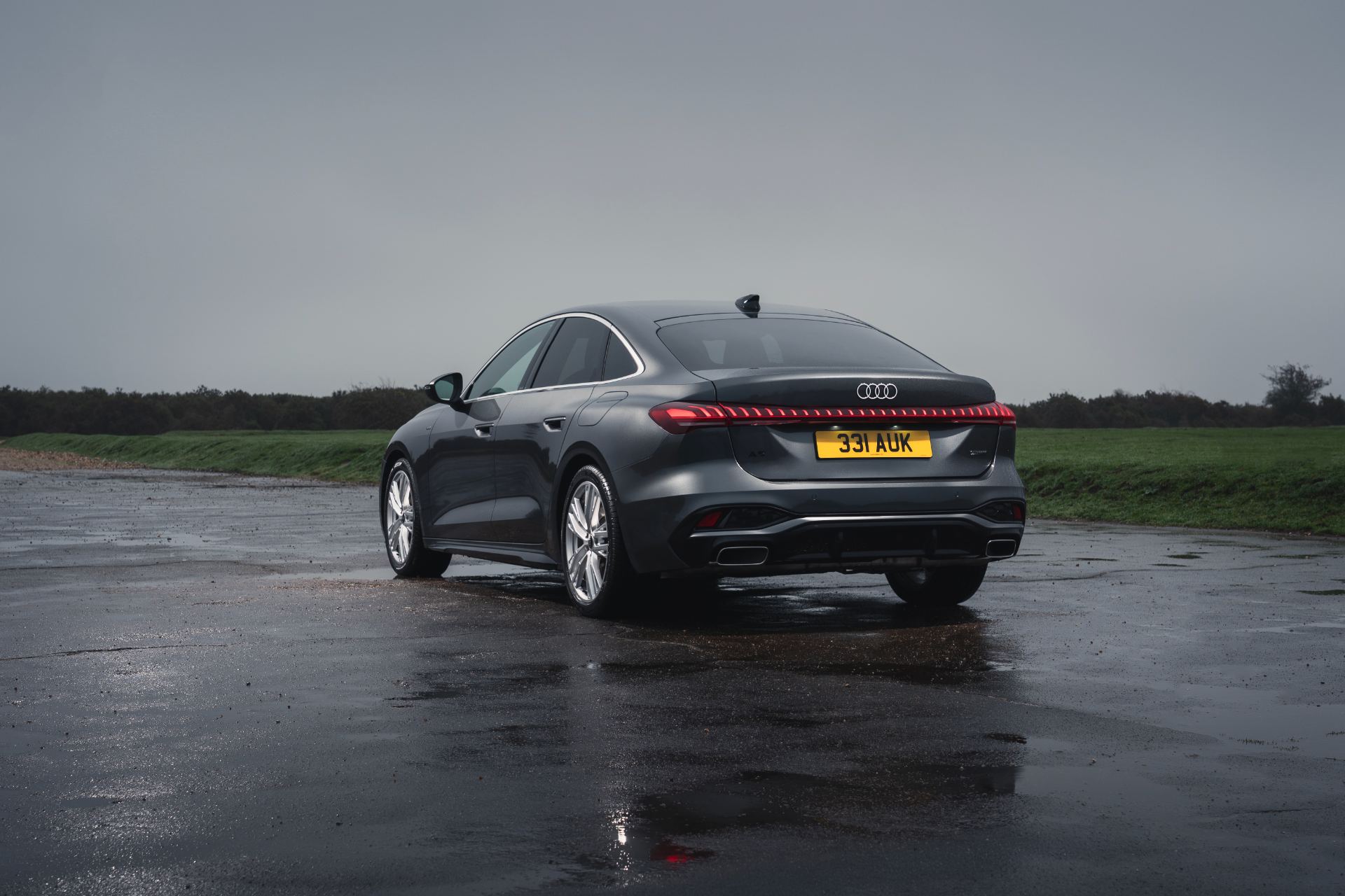 2026 audi a5 saloon e hybrid rear three quarter wet airfield grey