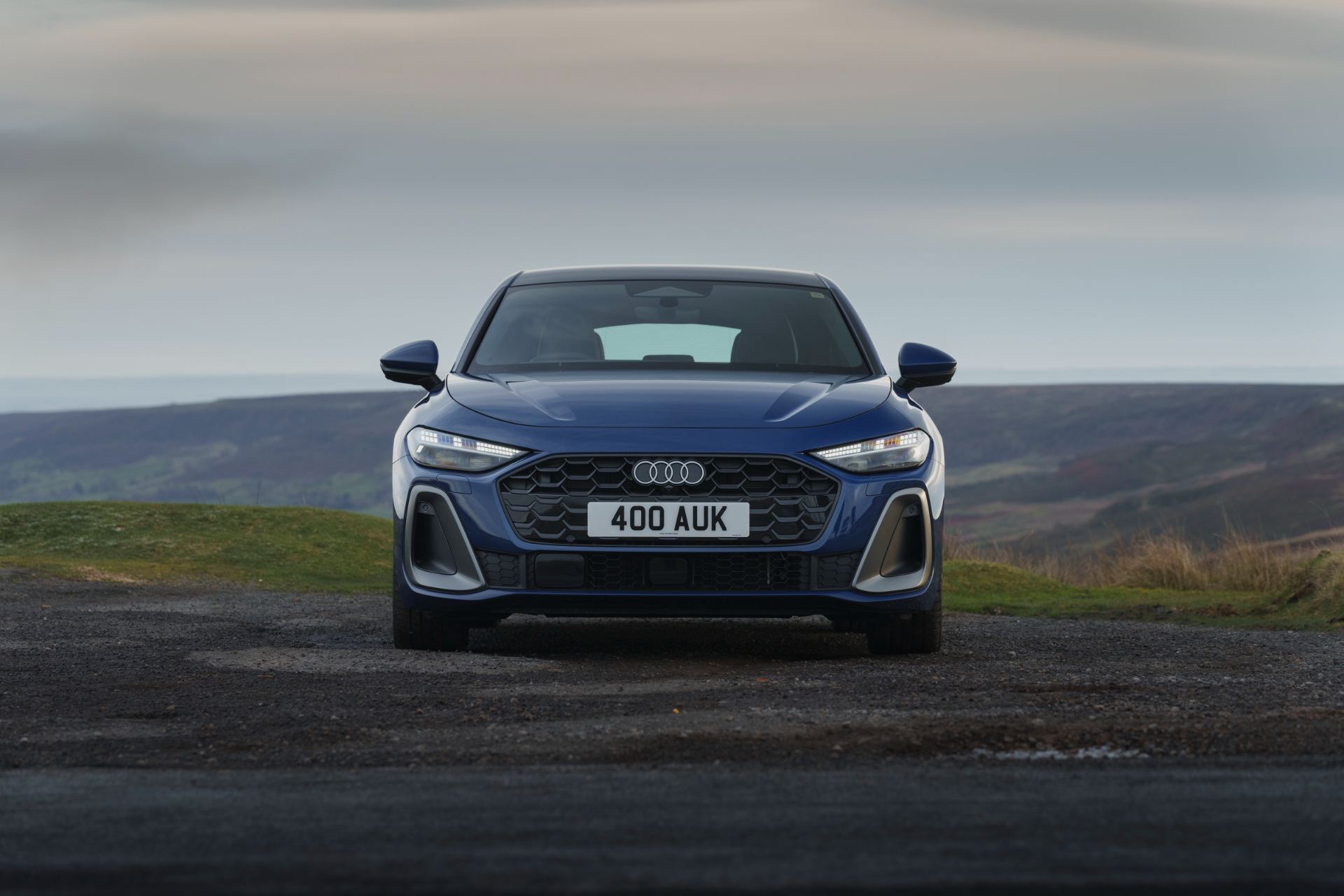 audi a5 saloon front distant moorland blue