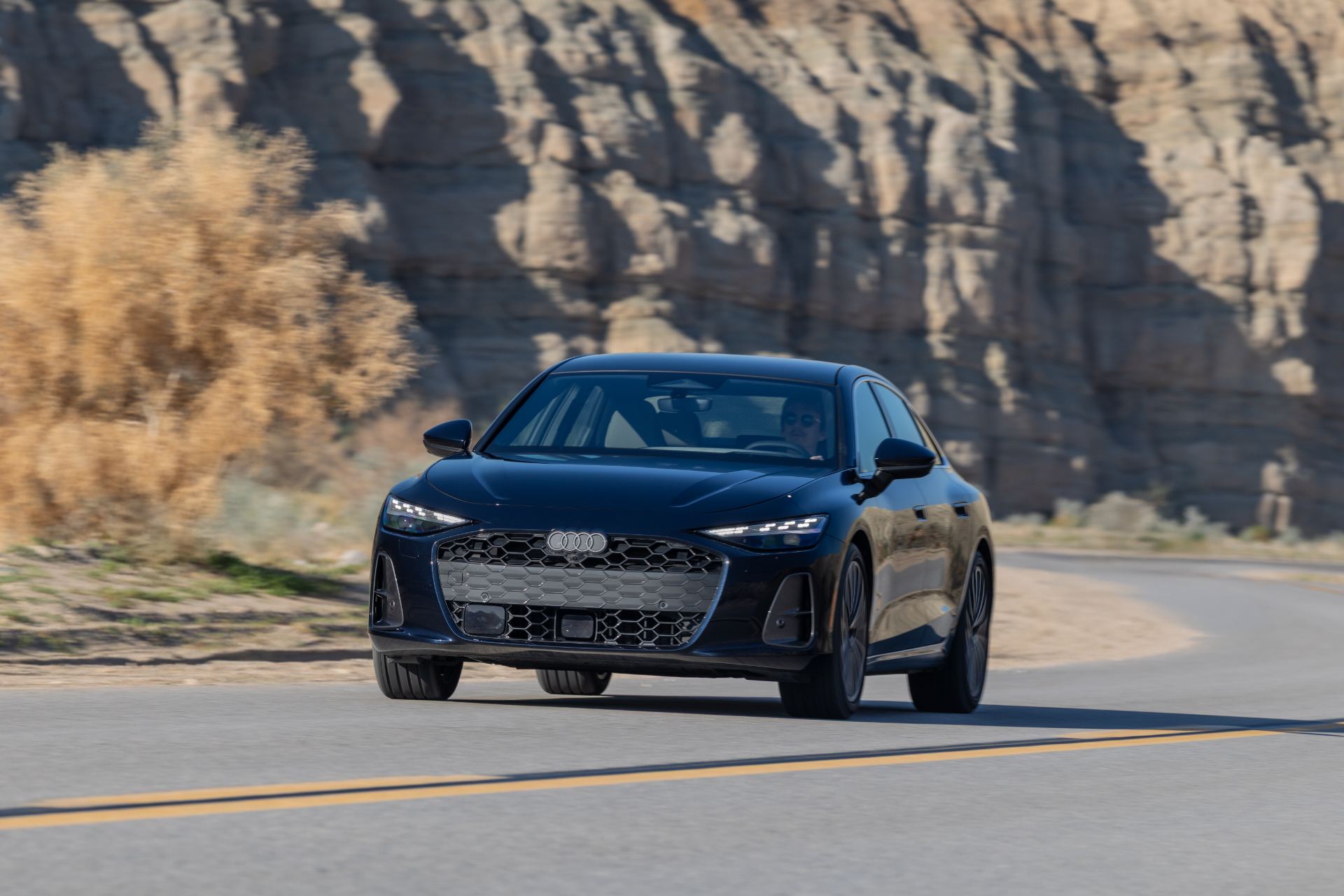2026 audi a6 driving front three quarter canyon dark blue