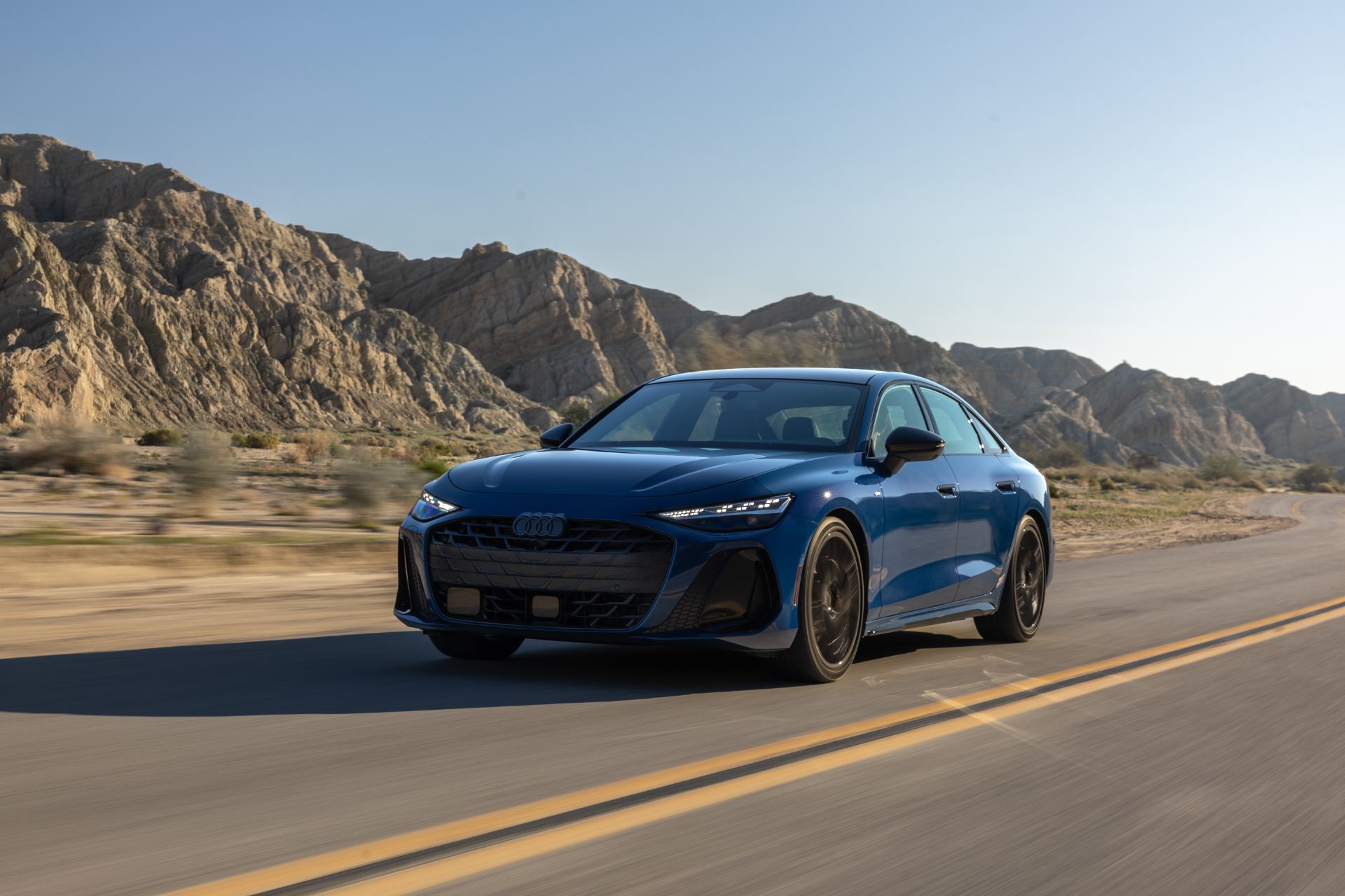 2026 audi a6 driving front three quarter desert blue