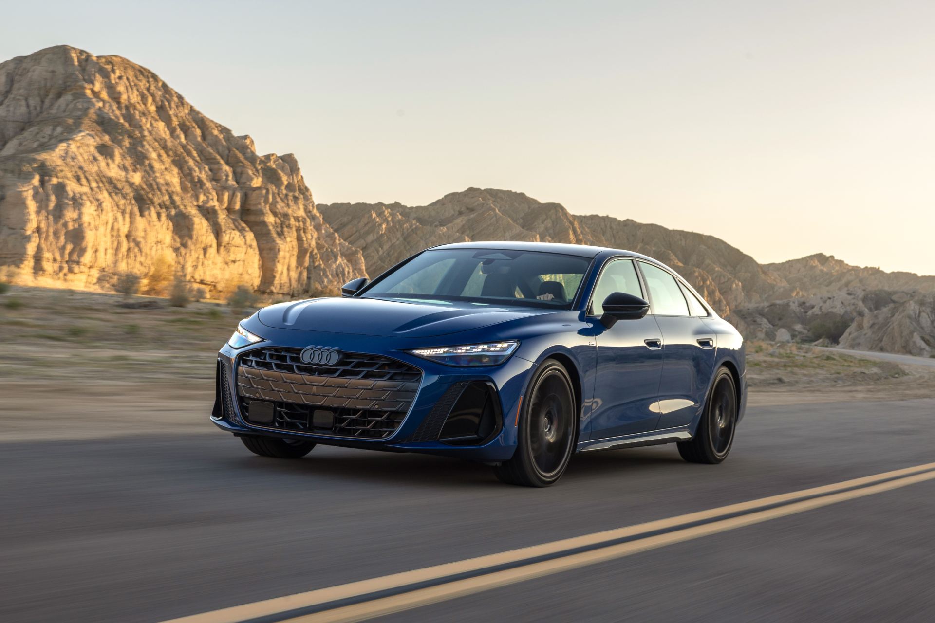 2026 audi a6 driving front three quarter canyon blue