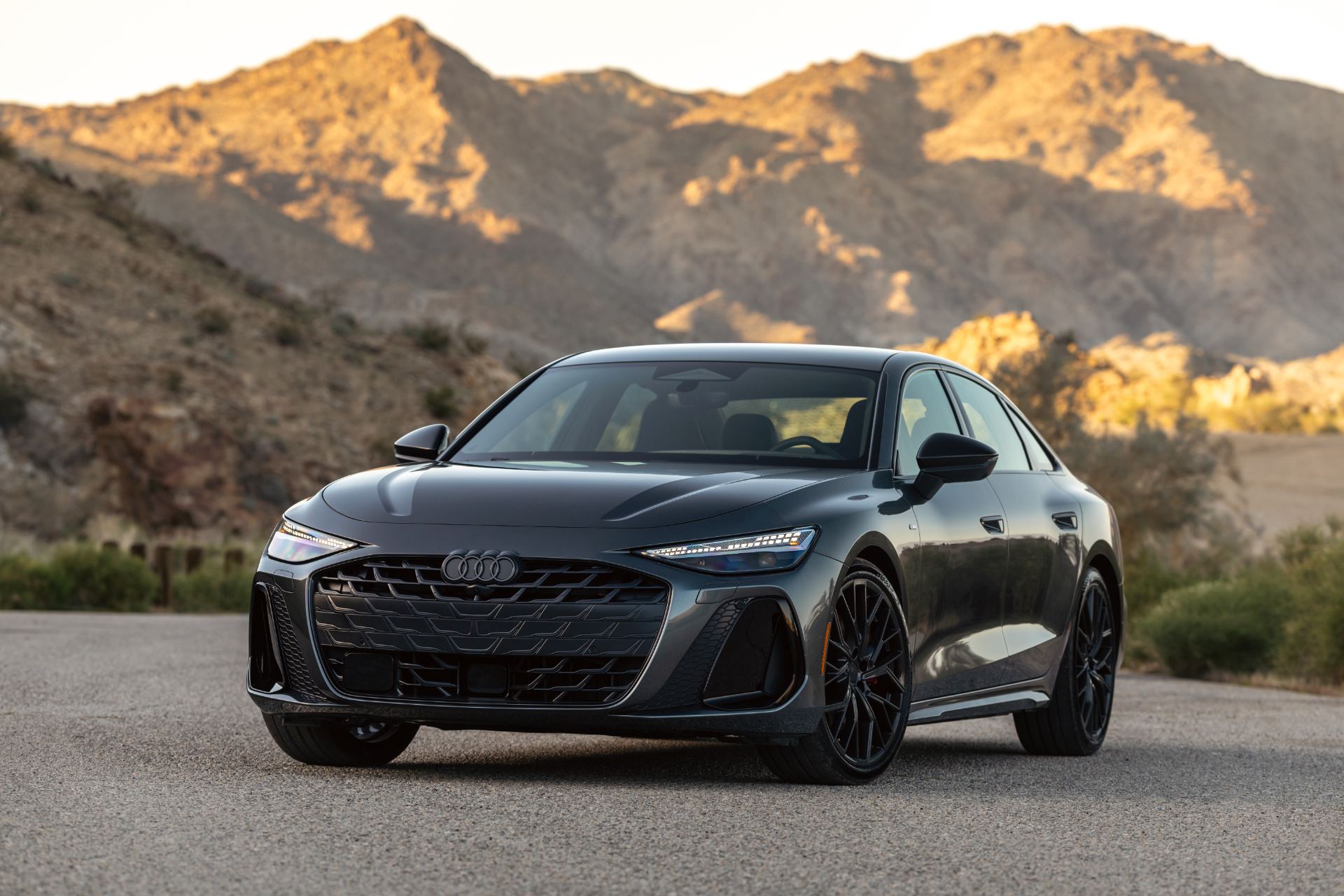 2026 audi a6 front three quarter sunlit rocks grey
