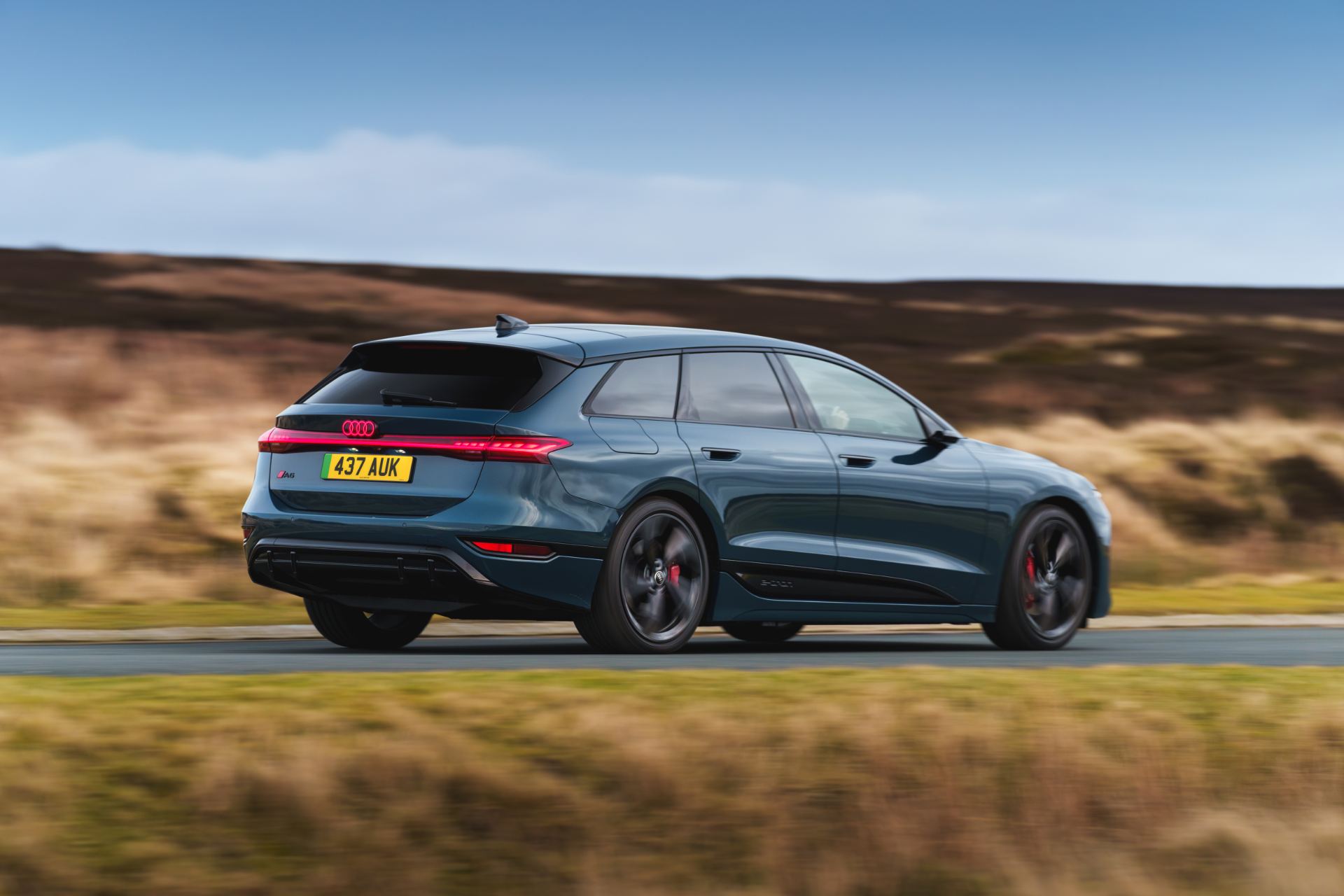 2026 audi a6 avant e tron driving rear three quarter blue