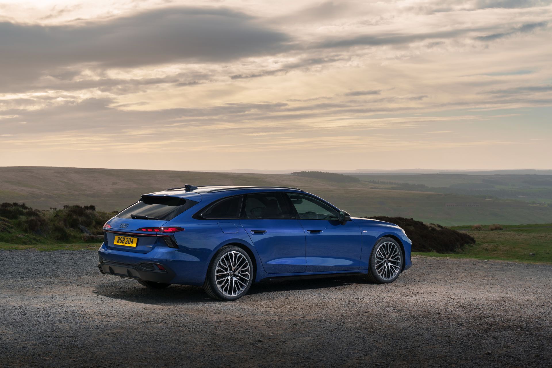 2026 audi a6 avant rear three quarter moorland sunset blue