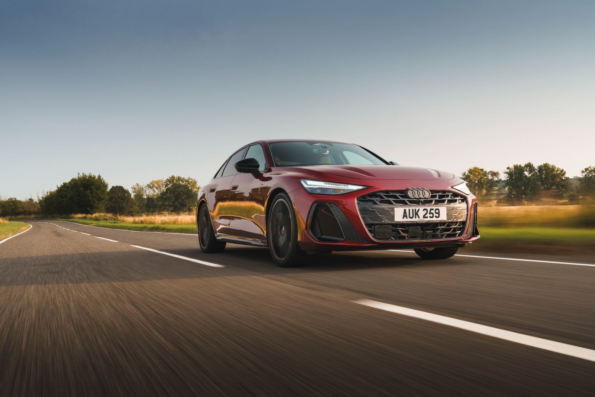2026 audi a6 saloon e hybrid driving front three quarter red