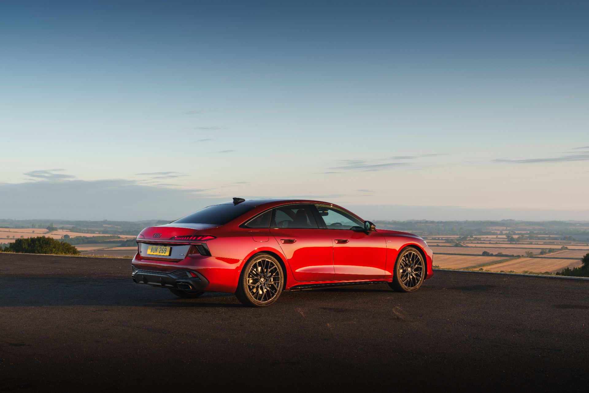 2026 audi a6 saloon e hybrid rear three quarter countryside red
