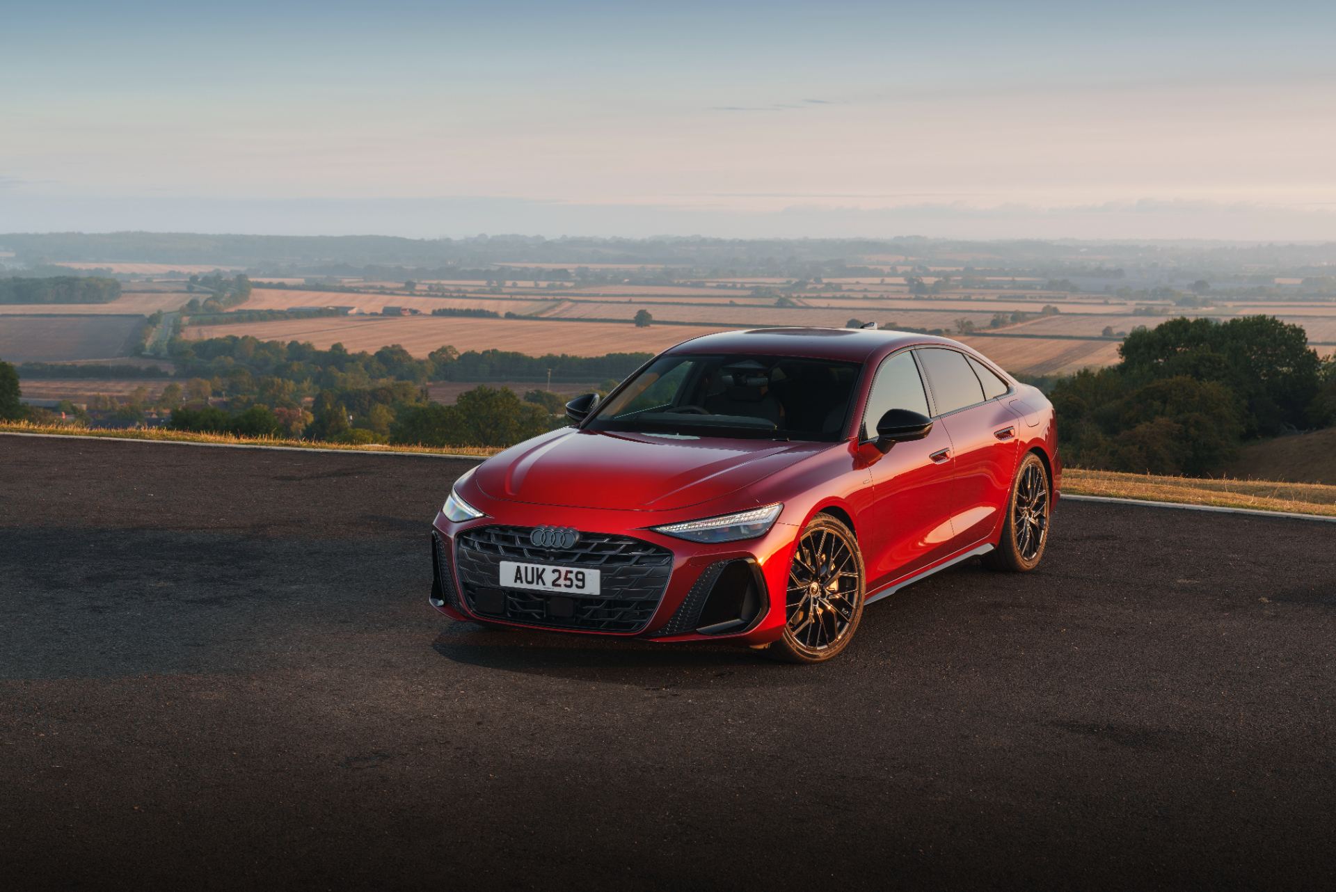 2026 audi a6 saloon e hybrid front three quarter hilltop red