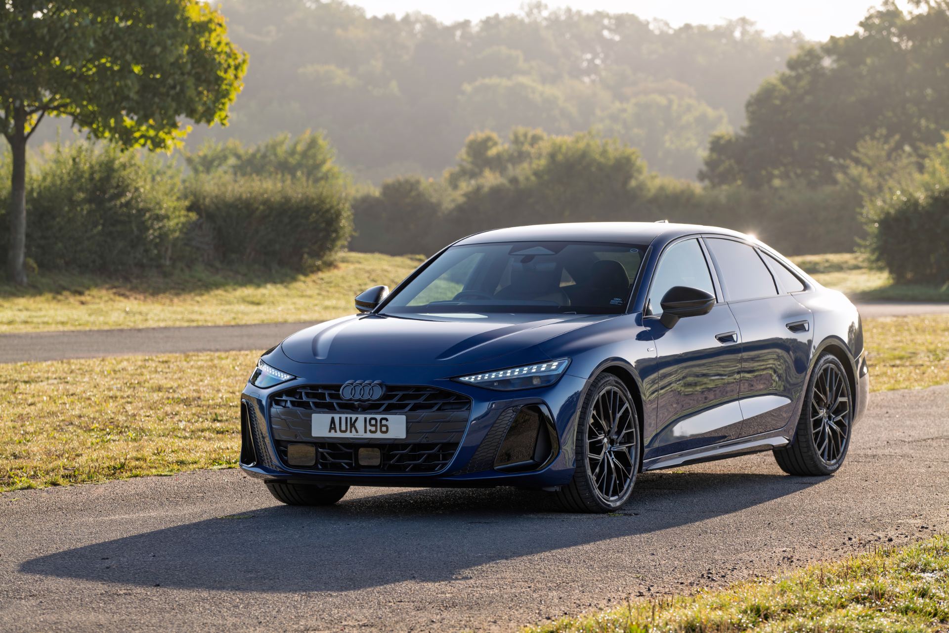 2026 audi a6 saloon front three quarter sunlit blue