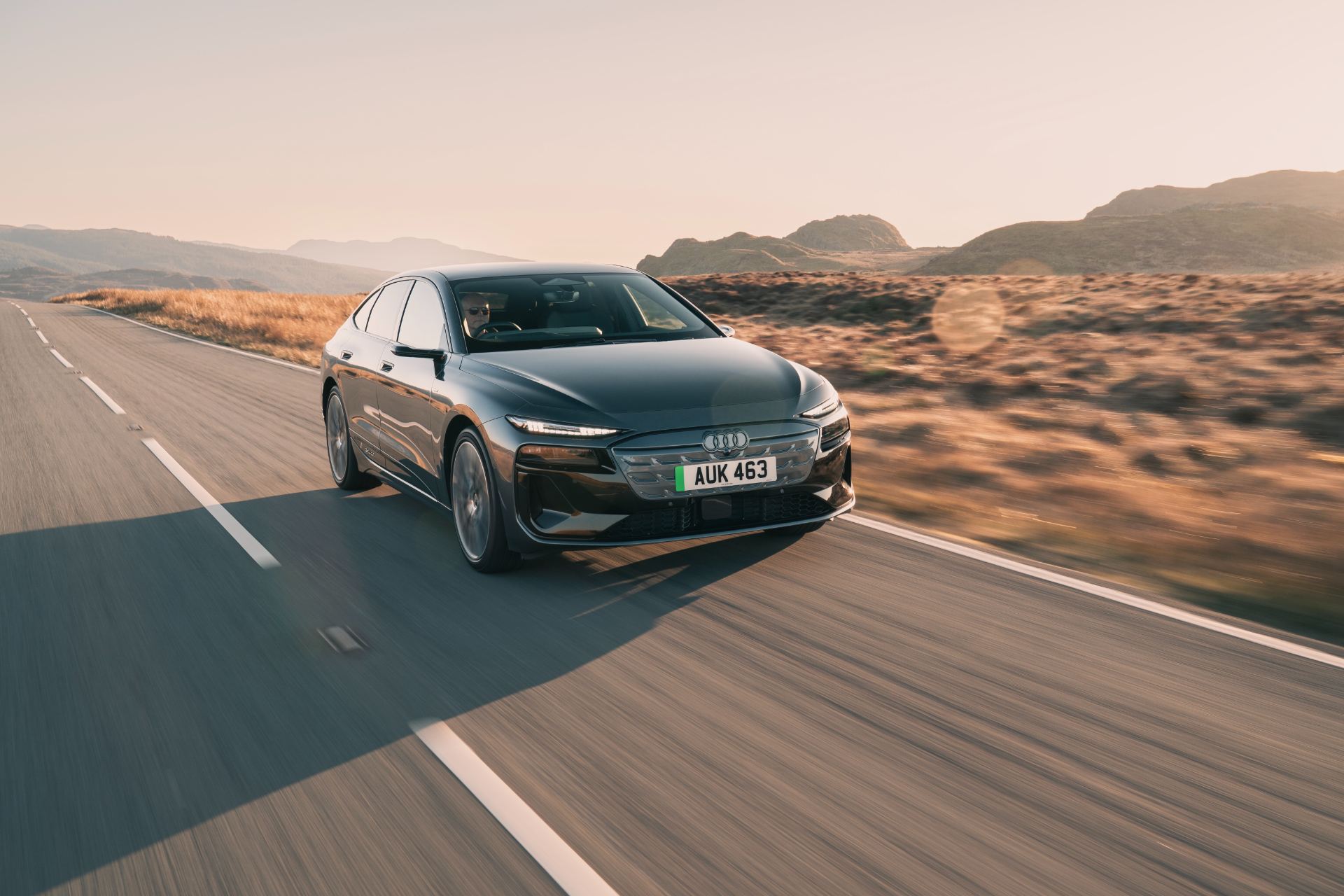 2026 audi a6 sportback e tron driving front three quarter sunset grey