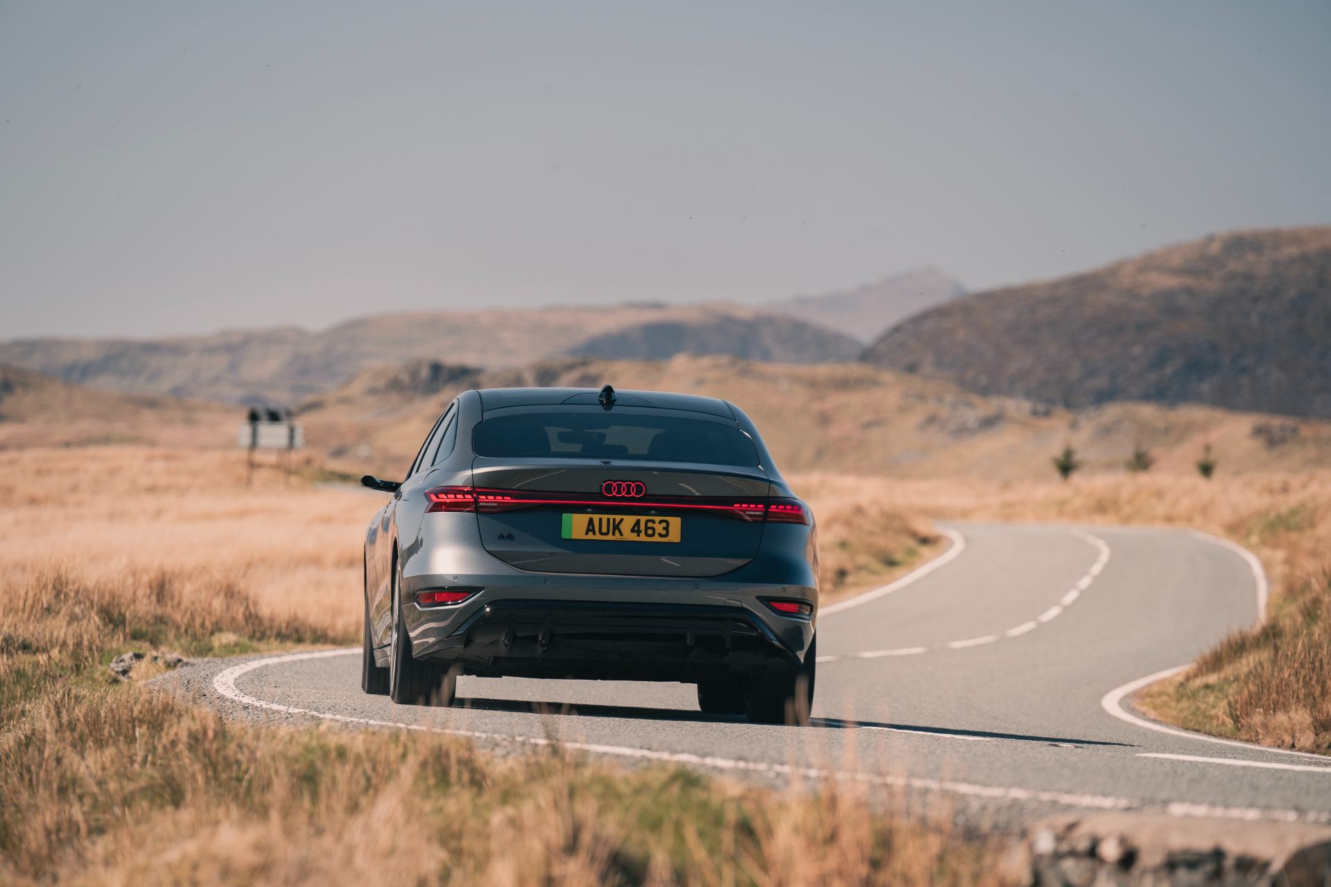 2026 audi a6 sportback e tron driving rear bend grey