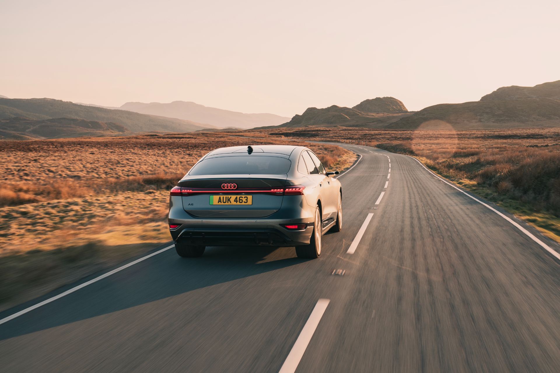 2026 audi a6 sportback e tron driving rear sunset grey