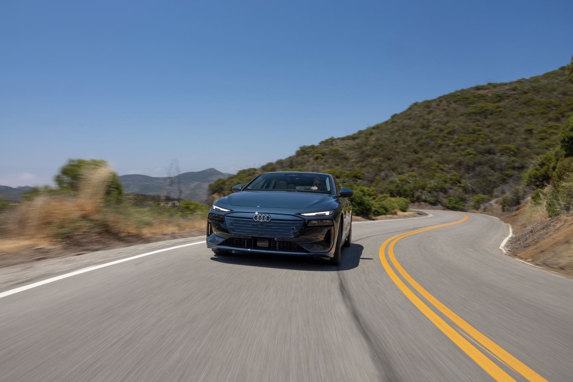 2027 audi a6 sportback e tron driving front winding road grey