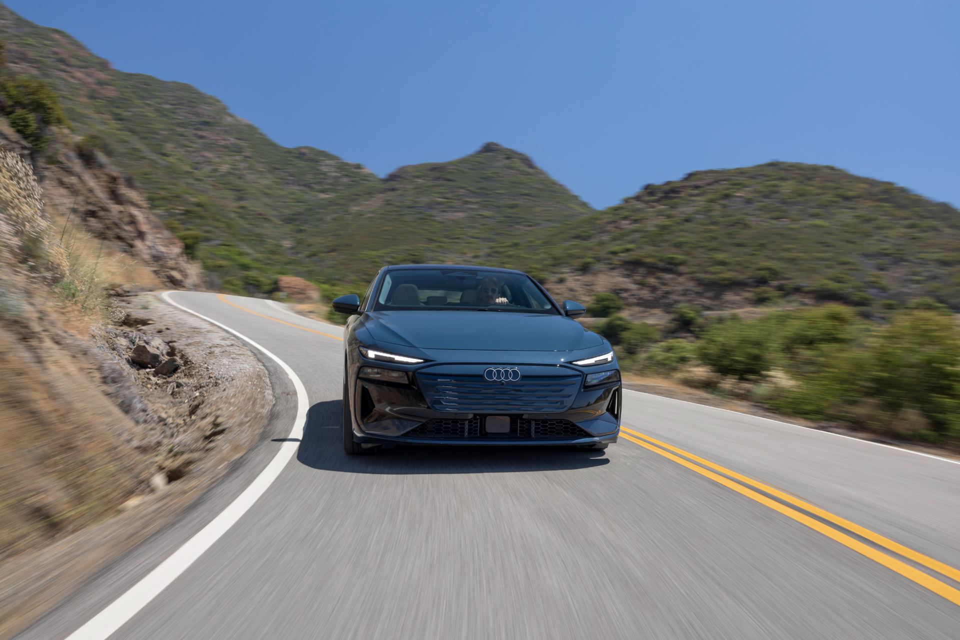 2027 audi a6 sportback e tron driving front canyon road grey