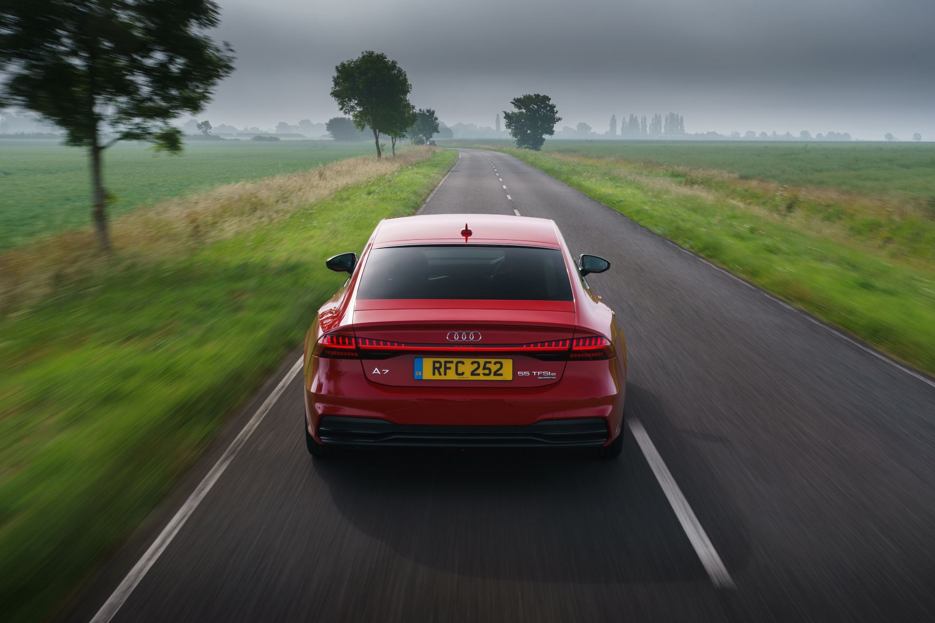 2025 audi a7 sportback driving rear avenue red