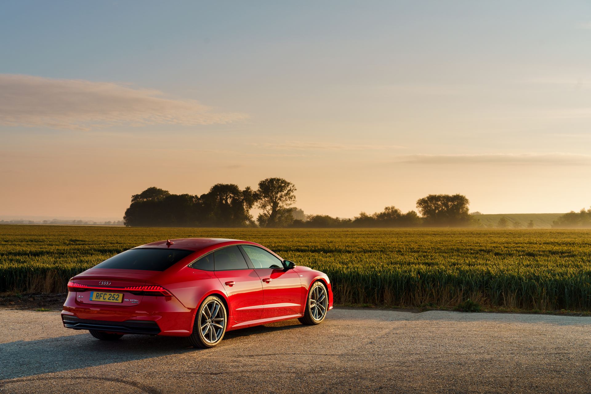 2025 audi a7 sportback rear three quarter golden hour red