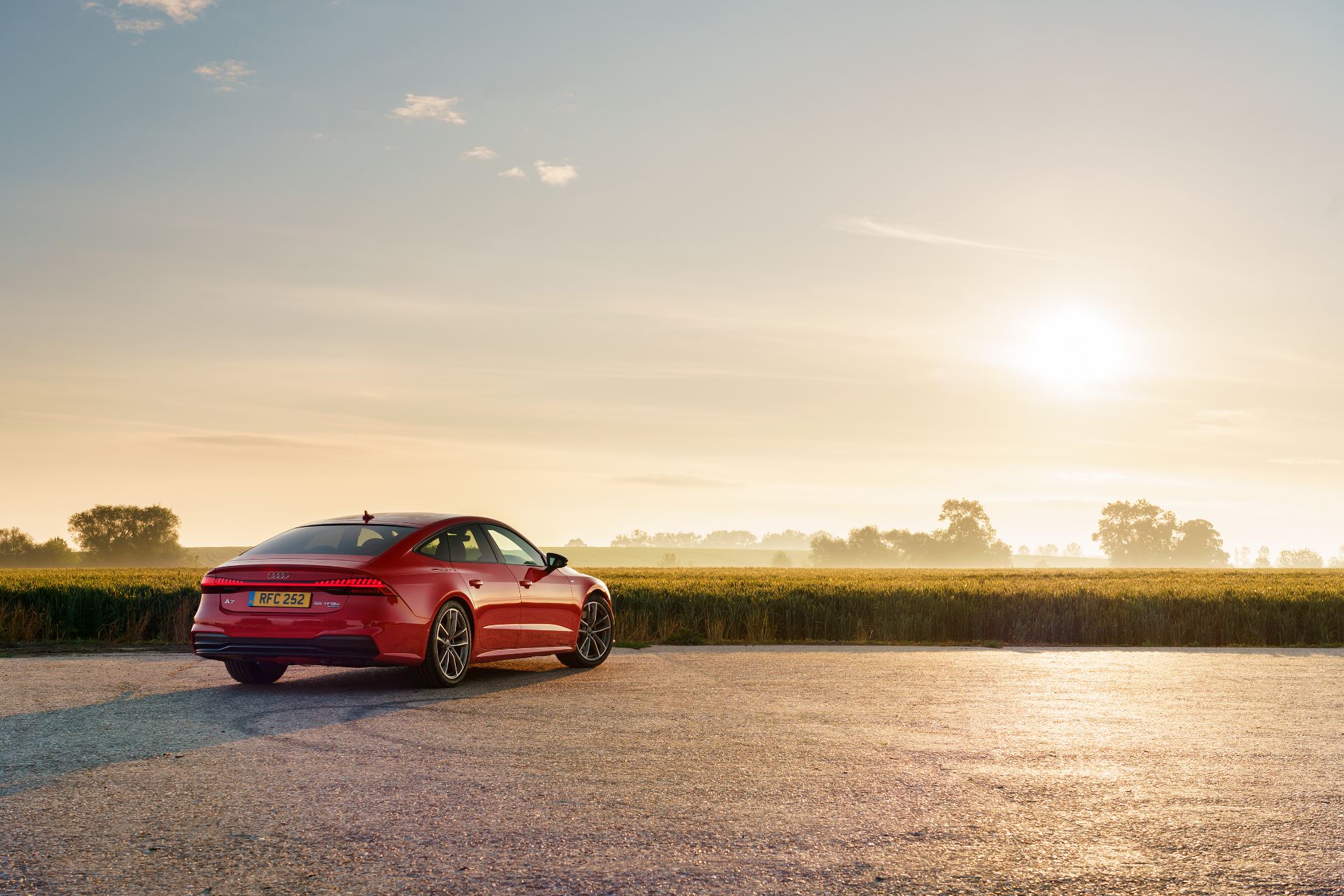 2025 audi a7 sportback rear three quarter distant sunrise red