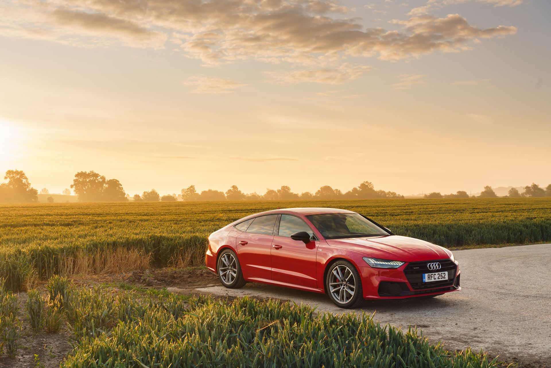 2025 audi a7 sportback front three quarter golden hour red