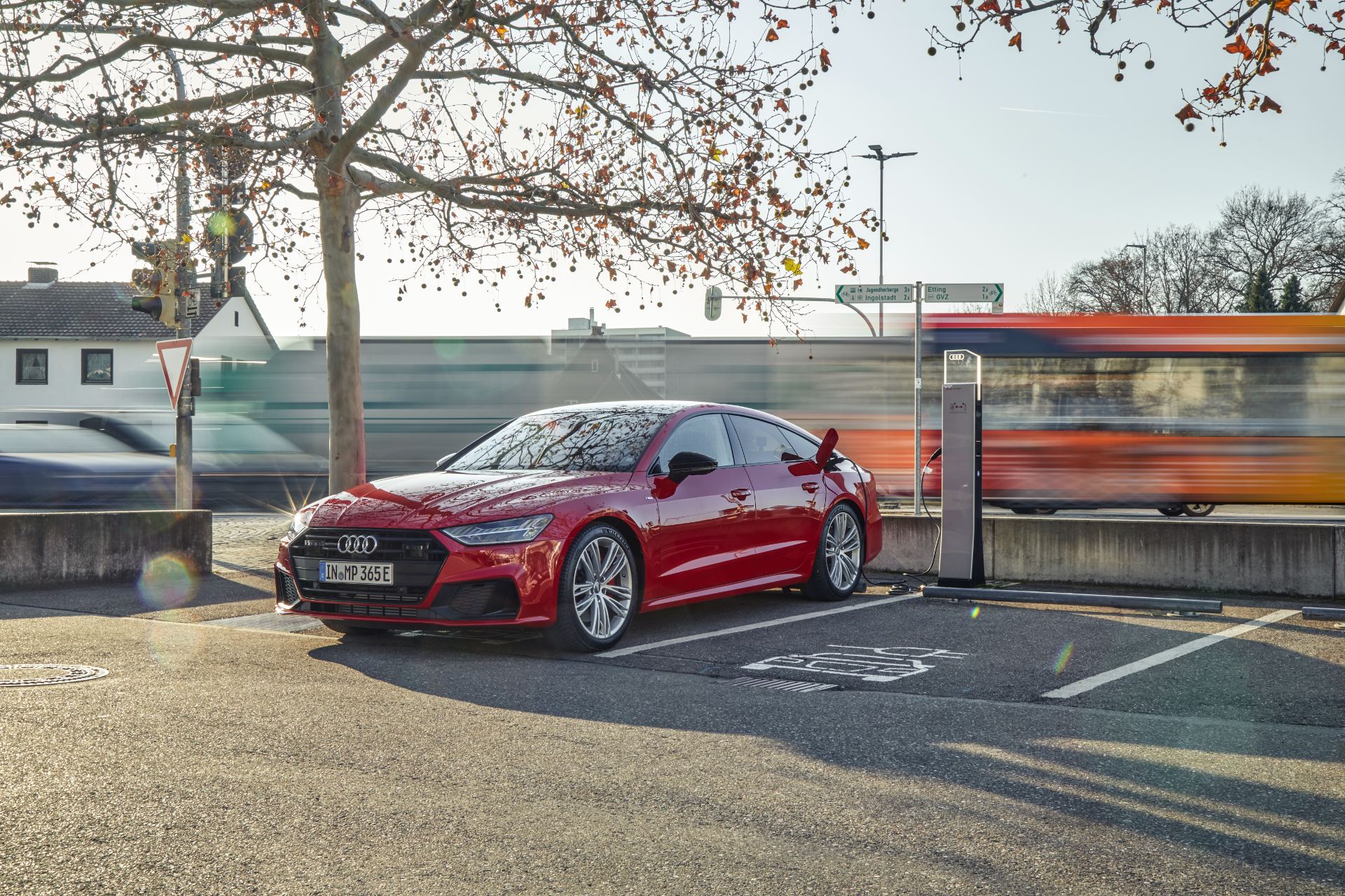 2025 audi a7 sportback front three quarter charging station red