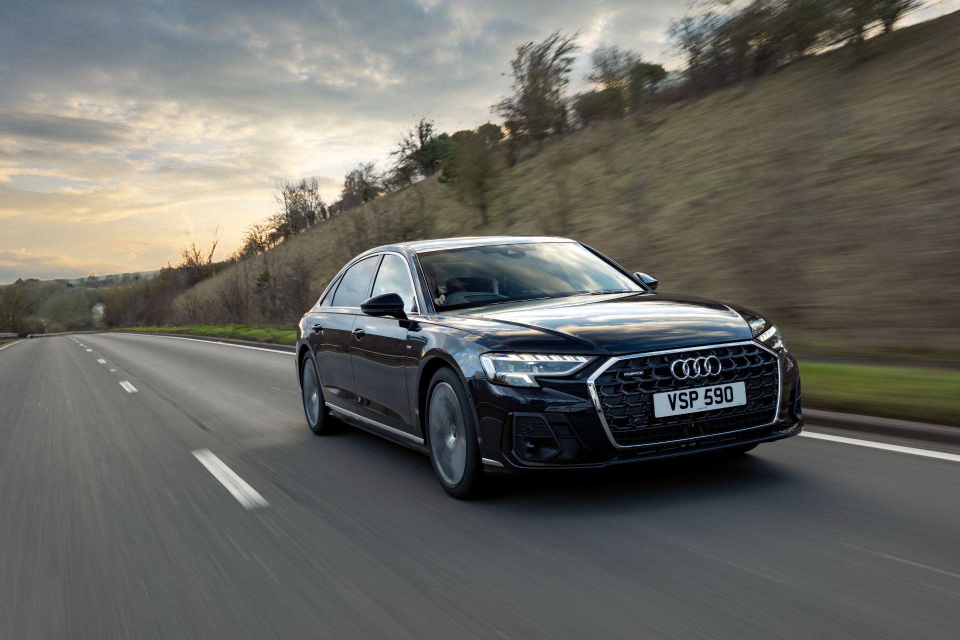 2025 audi a8 driving front three quarter embankment black