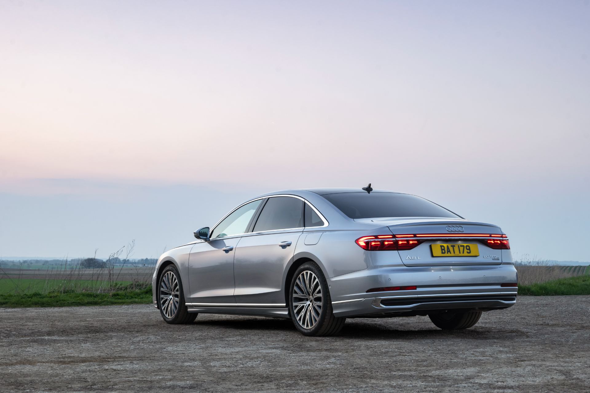 2025 audi a8 60 tfsi e rear three quarter dusk silver
