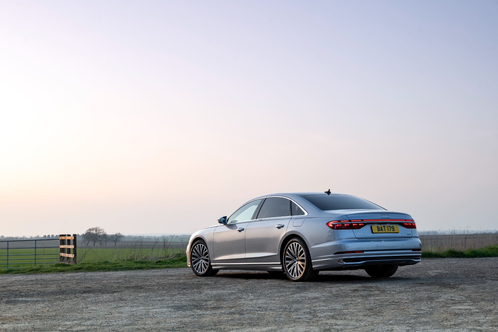 2025 audi a8 60 tfsi e rear three quarter distant dusk silver