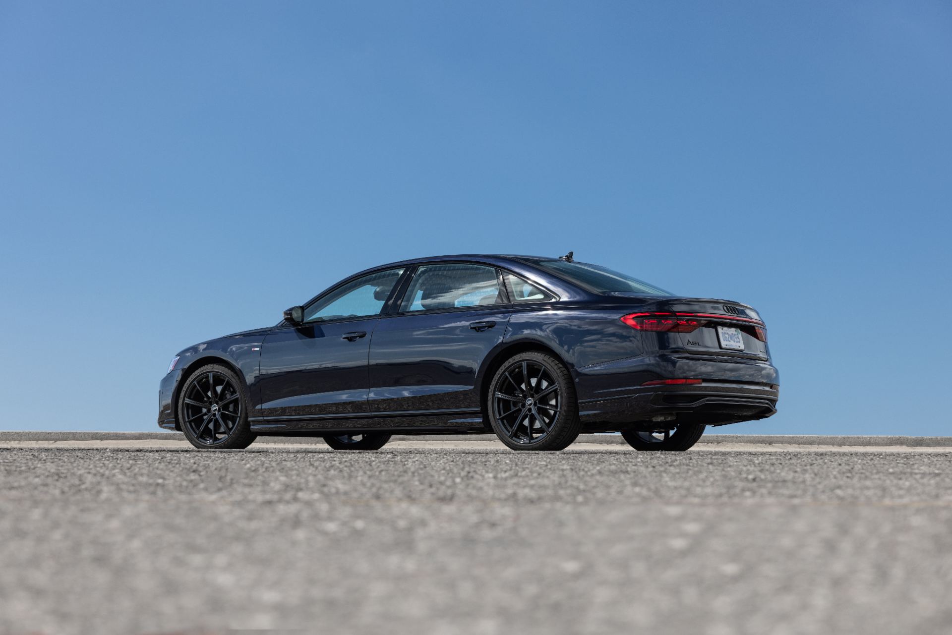 audi a8 l rear three quarter low angle dark blue
