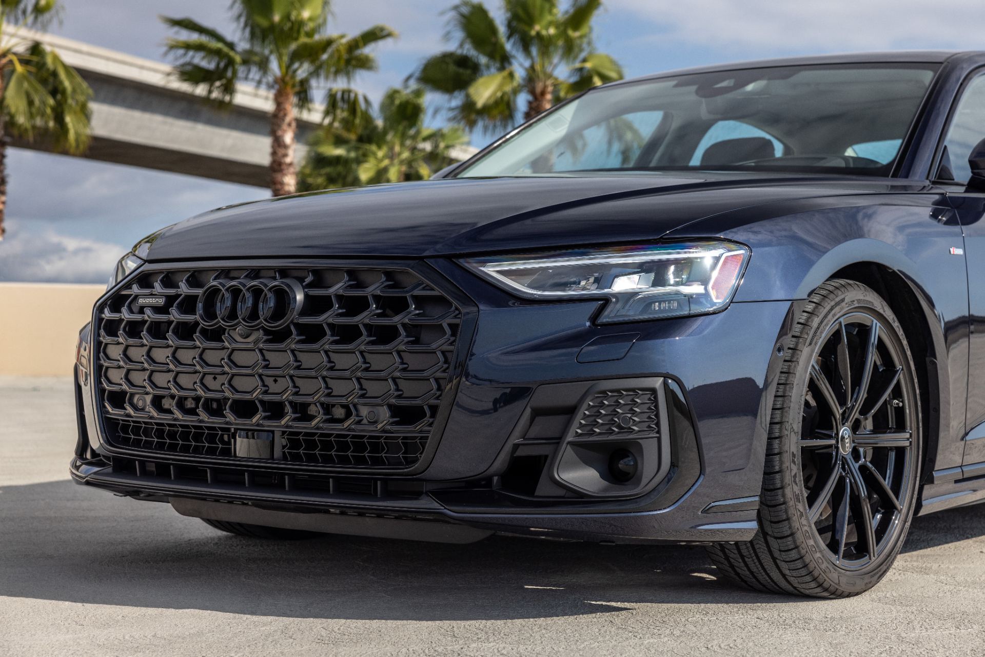 audi a8 l front detail palm trees dark blue