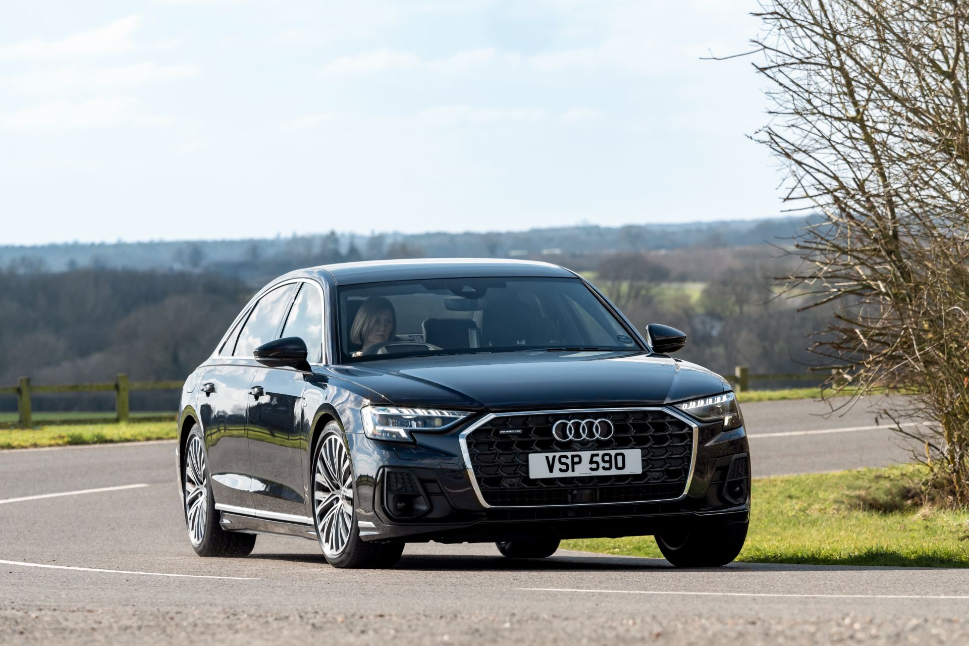 2025 audi a8 driving front three quarter black
