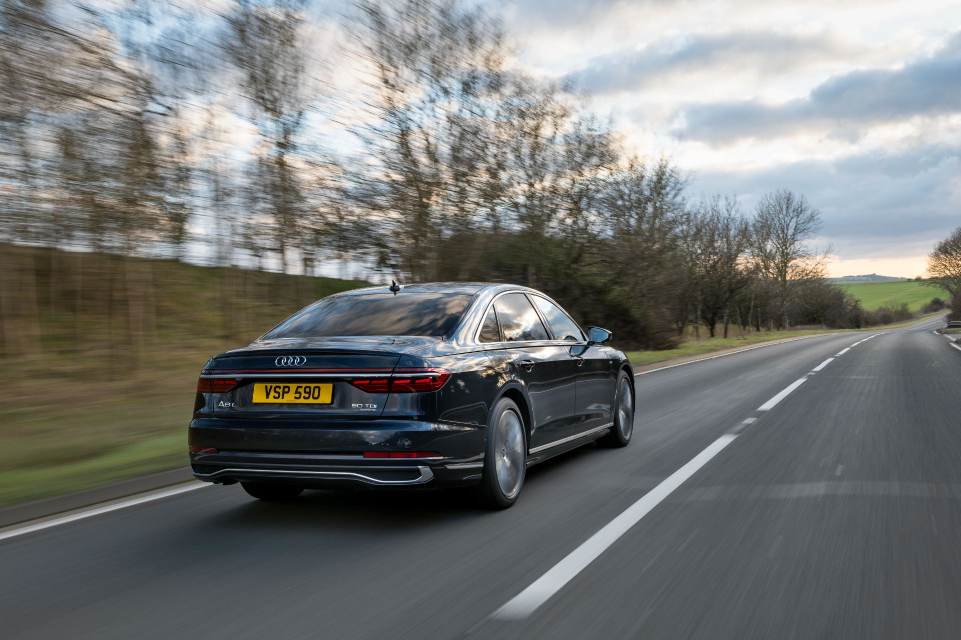 2025 audi a8 driving rear country road black