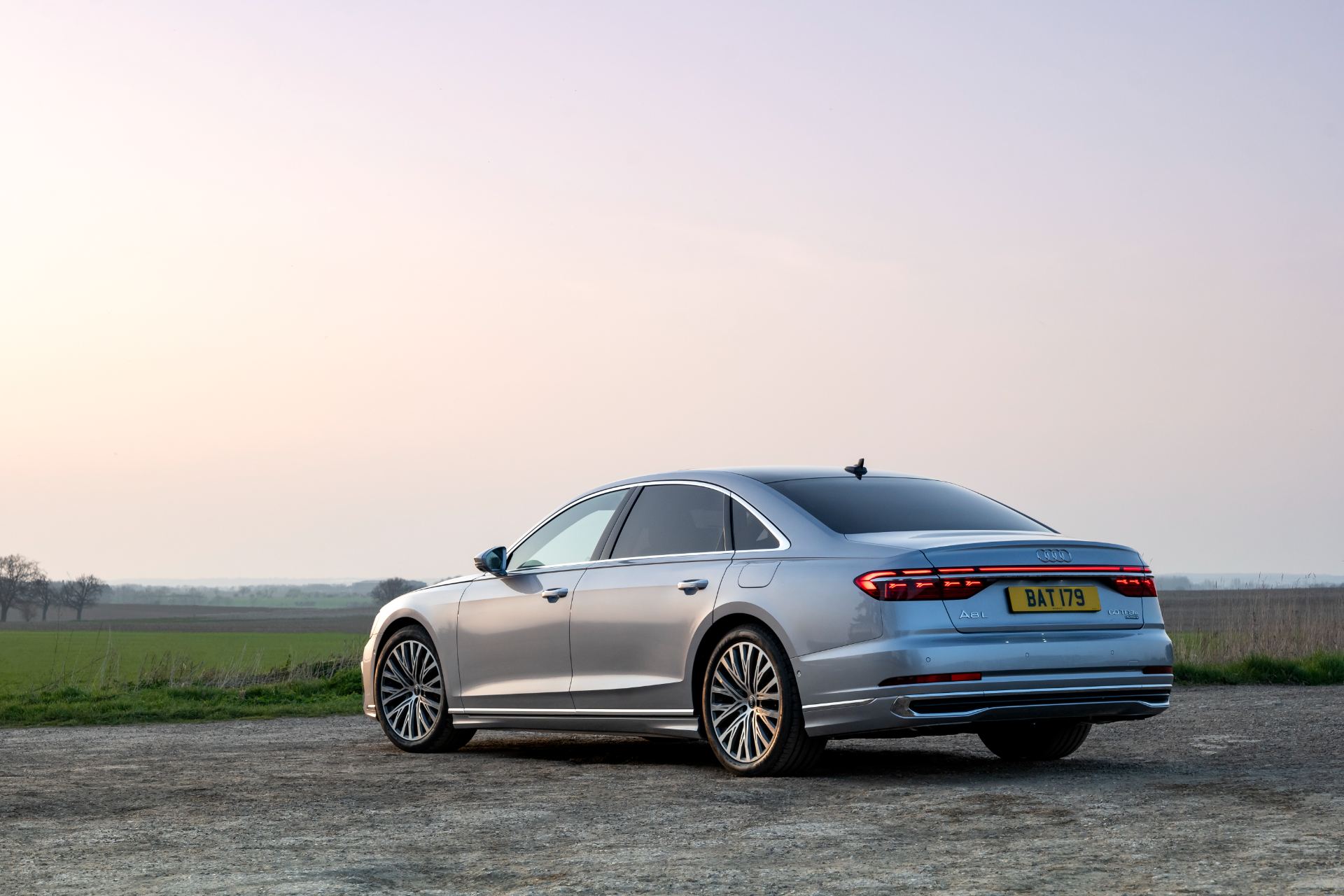 2025 audi a8 60 tfsi e rear three quarter field dusk silver