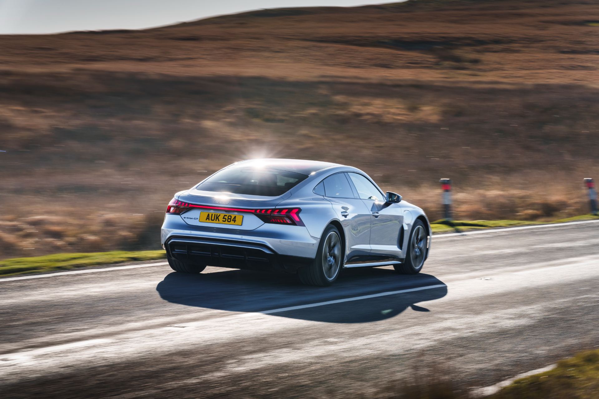 2026 audi e tron gt quattro driving rear three quarter silver