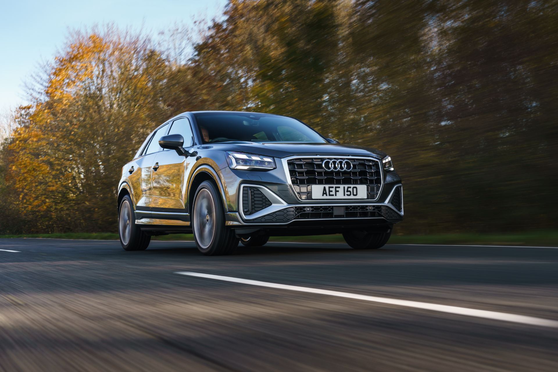 2025 audi q2 driving front three quarter autumn road grey