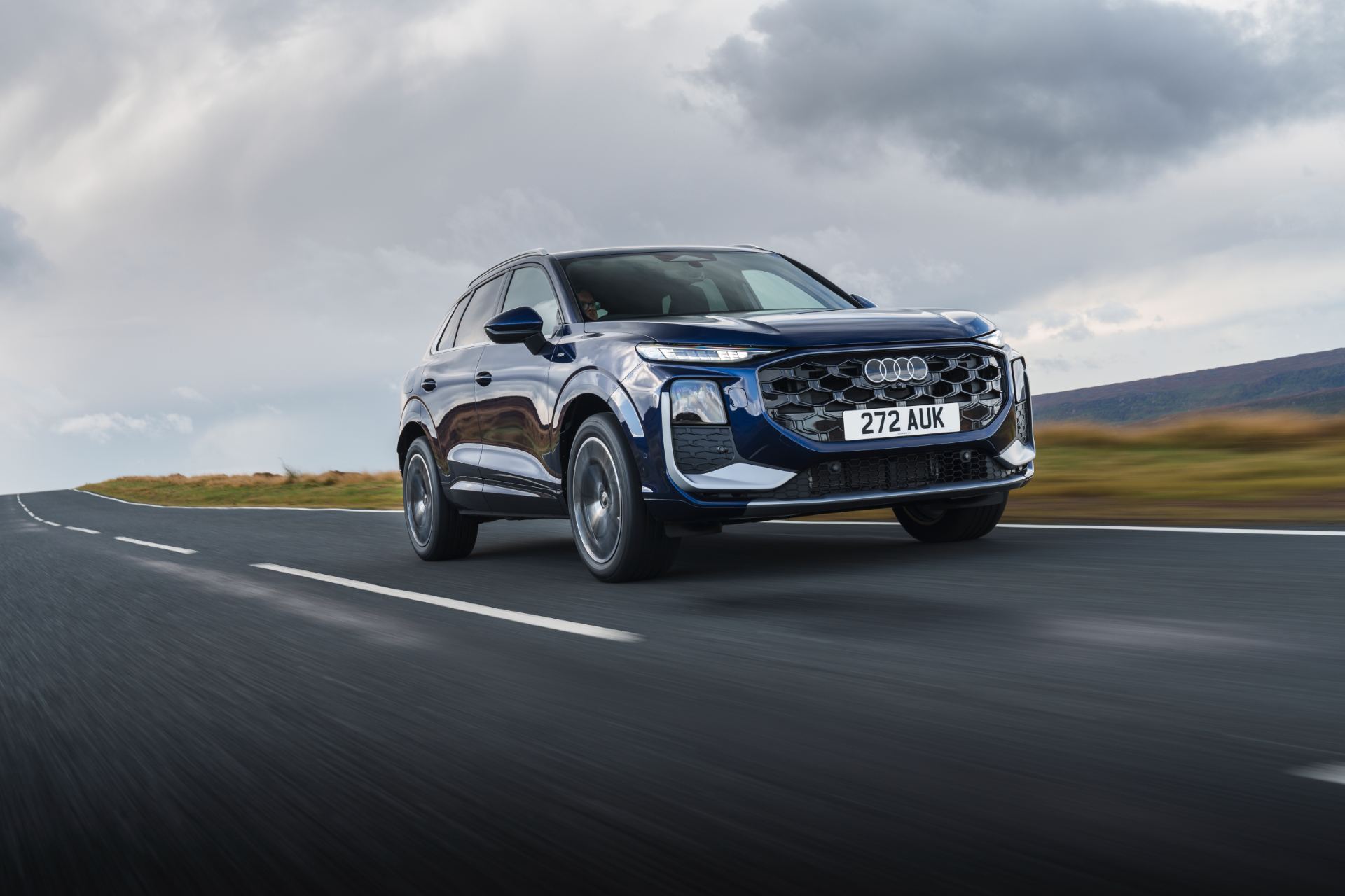 2026 audi q3 e hybrid driving front three quarter blue