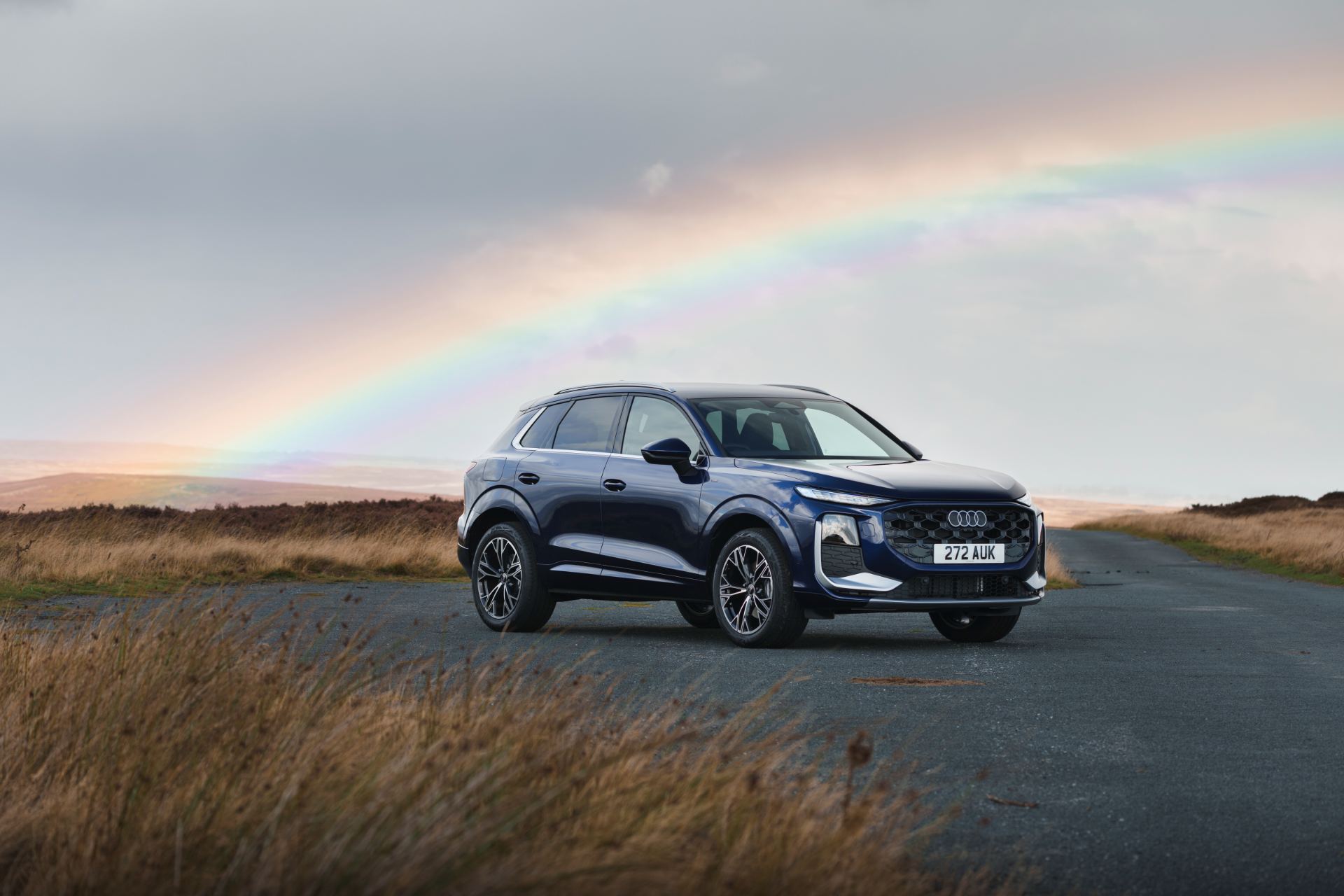 2026 audi q3 e hybrid front three quarter rainbow blue