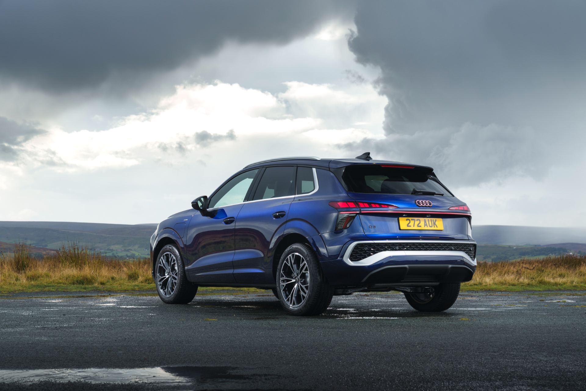 2026 audi q3 e hybrid rear three quarter moorland blue
