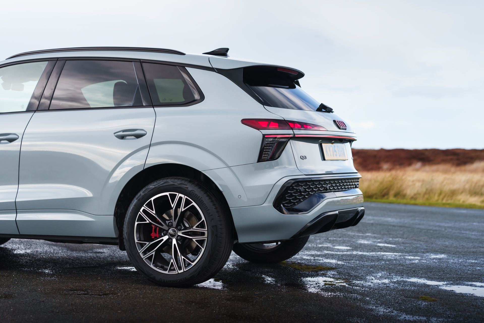 2026 audi q3 rear three quarter wet tarmac silver