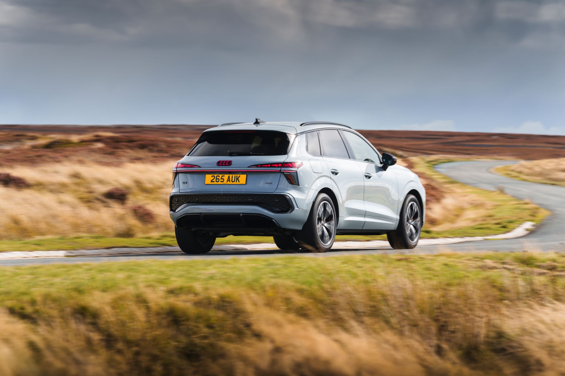2026 audi q3 driving rear three quarter bend silver
